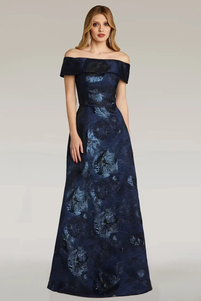 Model is wearing a strapless jacquard A-line gown with a cinched waist and lustrous texture.