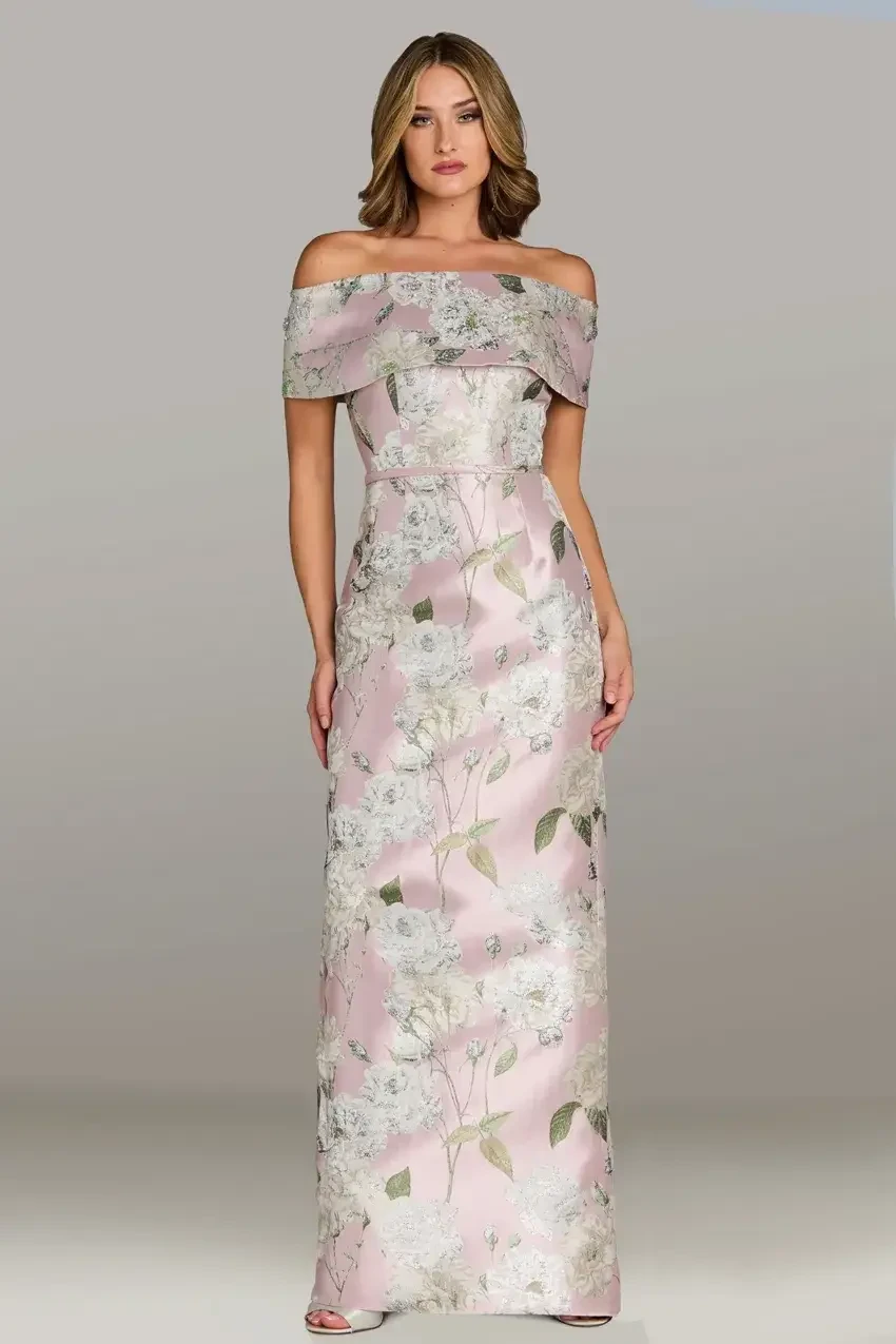 Model is wearing a fitted Mikado column gown with a strapless neckline, off-the-shoulder sleeves, and a slit.