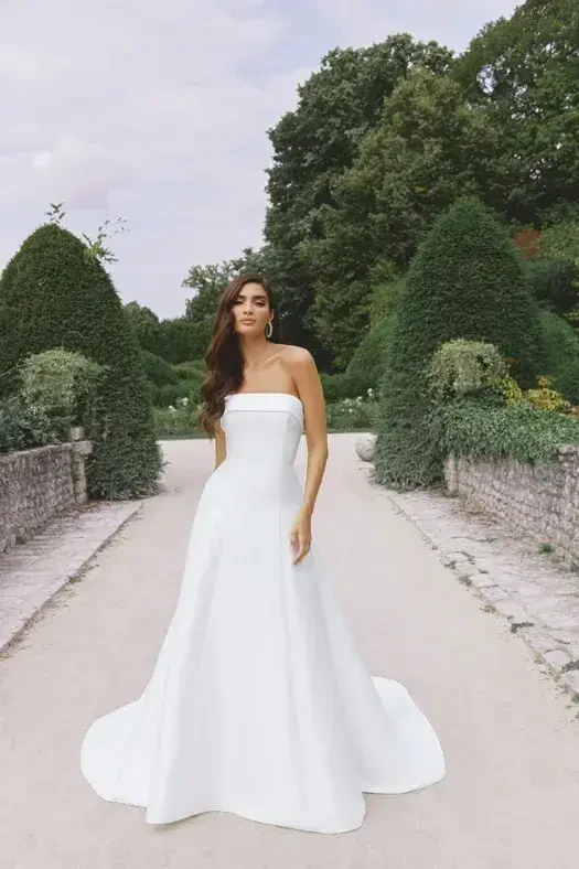 model is wearing a strapless a-line wedding dress