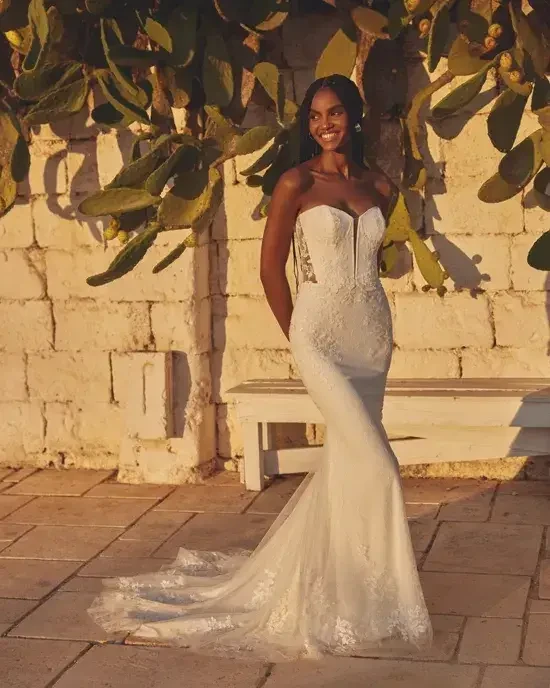 model is wearing a strapless fit and flare wedding dress