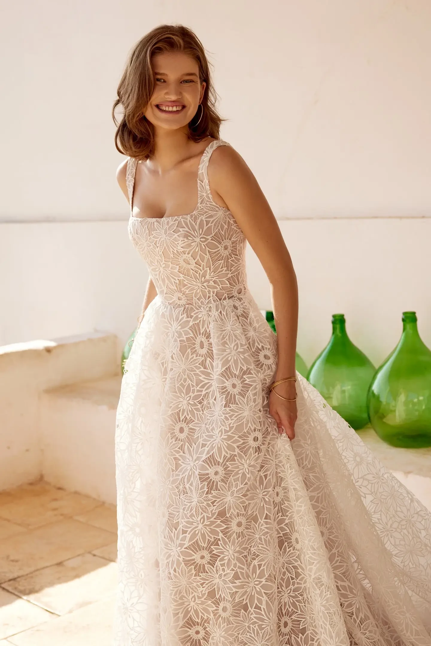 model is wearing a sleeveless a-line wedding dress with a square neckline