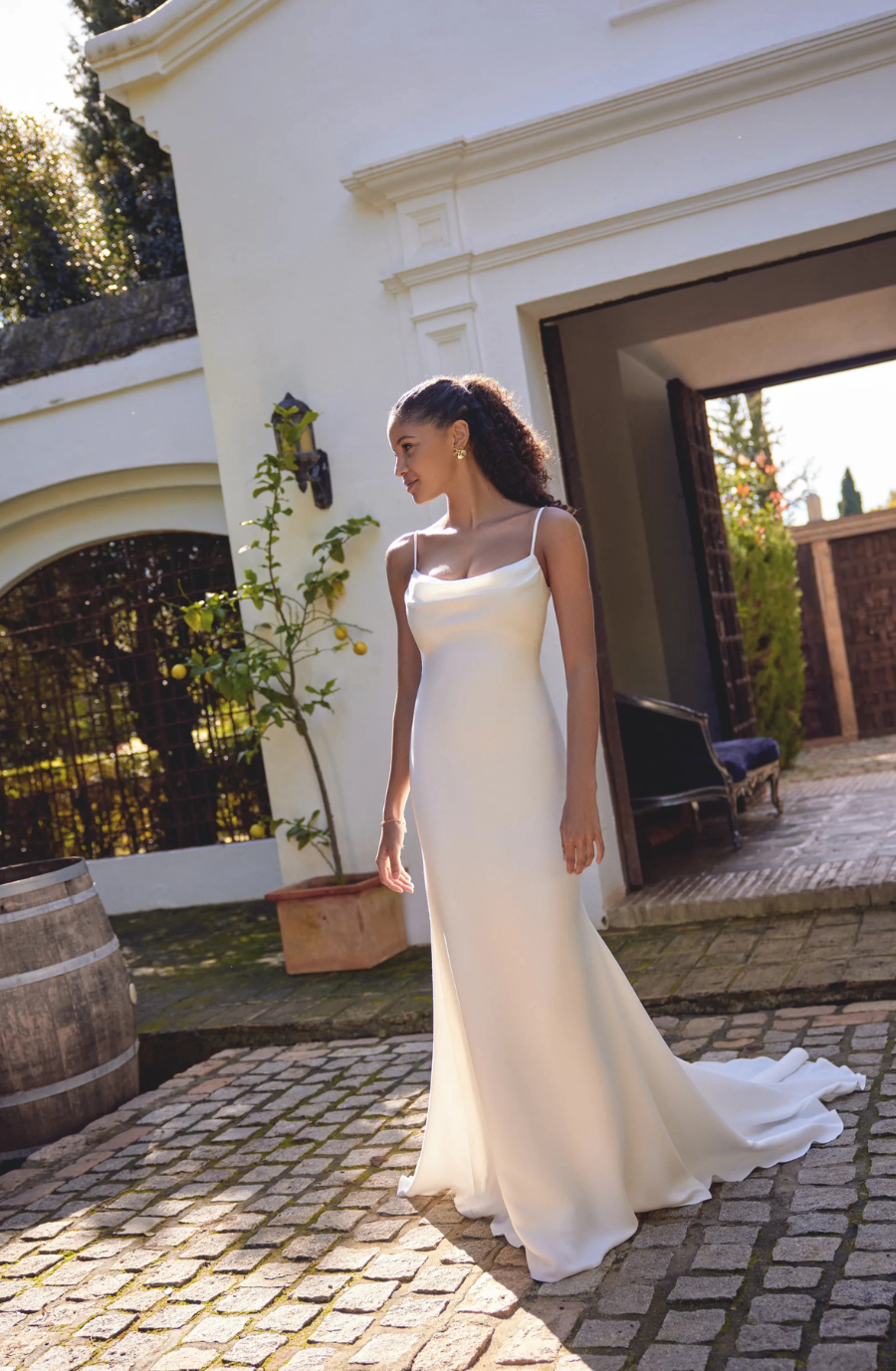 model is wearing a sleeveless fit and flare wedding gown