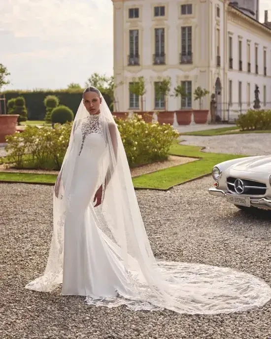 model is wearing a high neckline fitted wedding dress