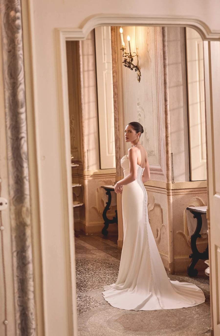 model is wearing a fit and flare wedding dress