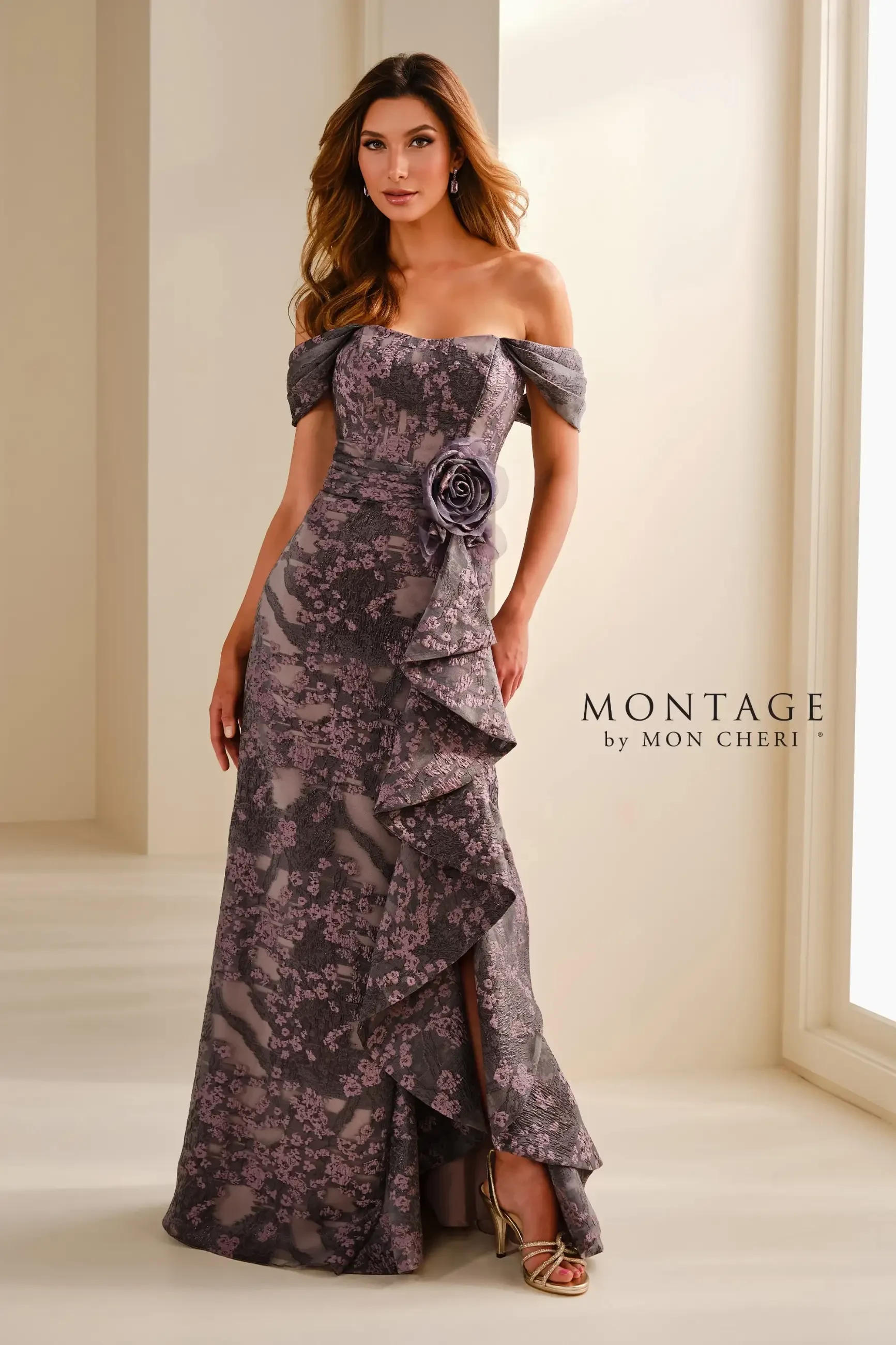 Model is wearing a floor-length eggplant brocade gown with a sweetheart neckline and fit-and-flare silhouette.