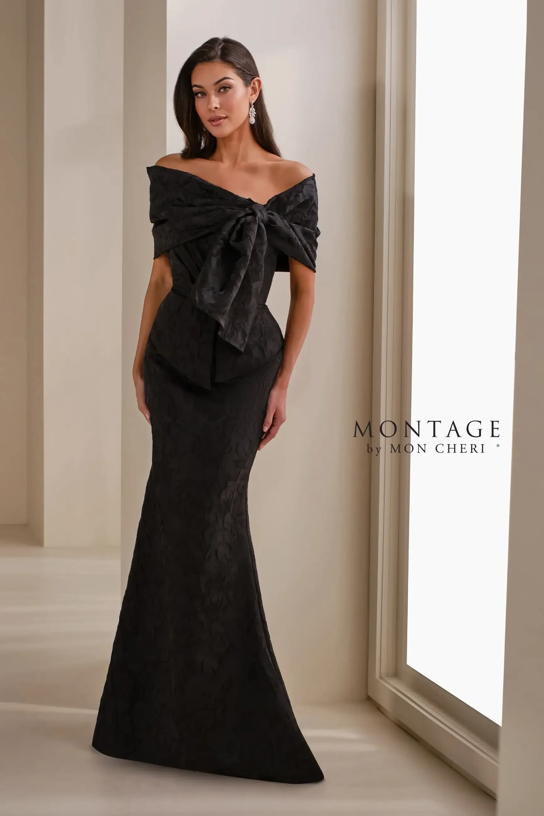 Model is wearing a brocade mermaid gown with a strapless sweetheart neckline, detachable tapered straps, and a matching wrap and belt.